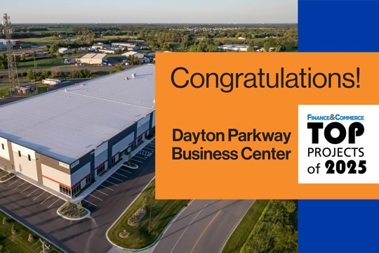 aerial of industrial building in background with graphic with words "Dayton Business Parkway Finance & Commerce Top Projects of 2025" in foreground